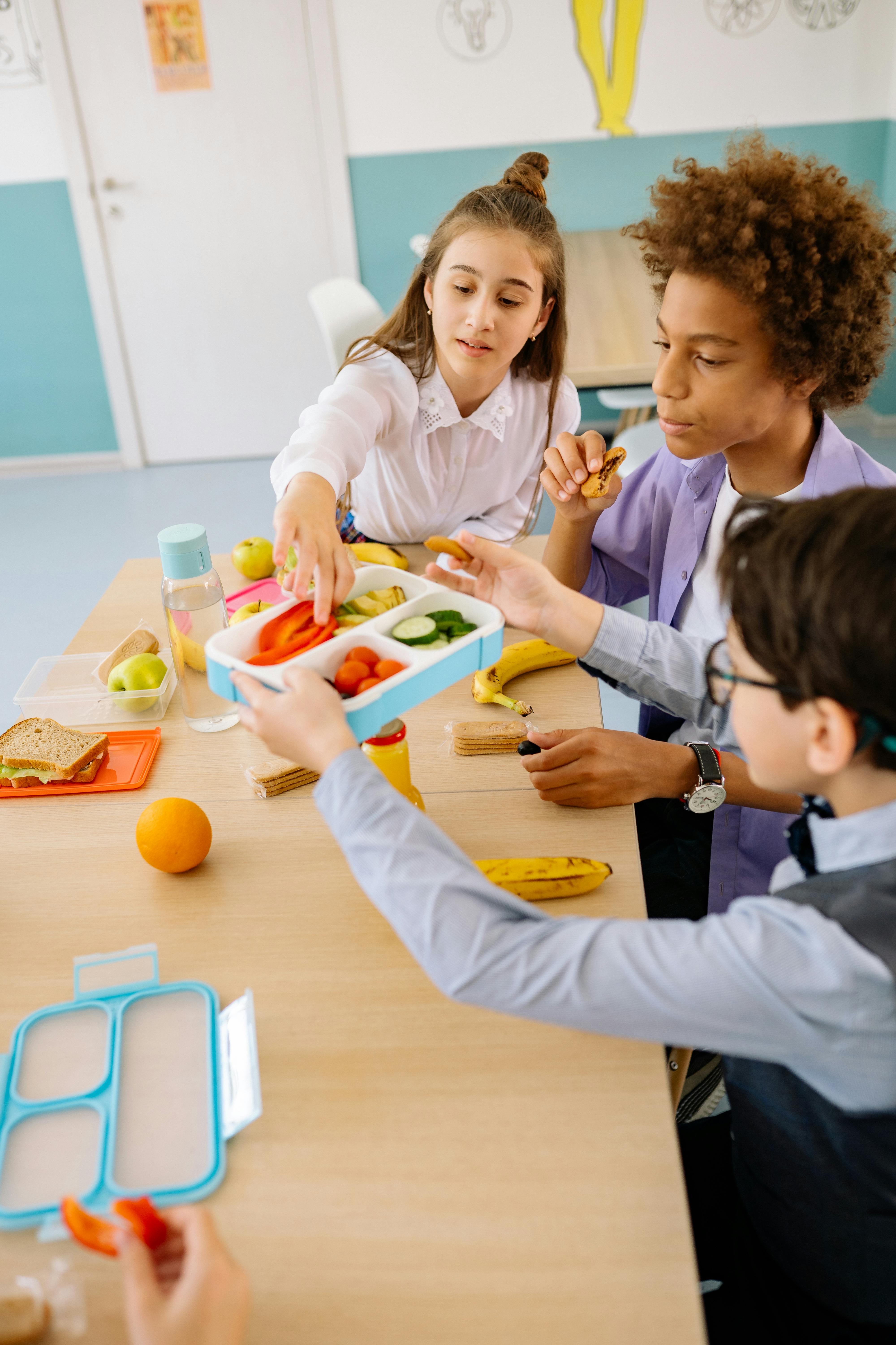 Children eating packed lunches together during school holiday activities and HAF provision